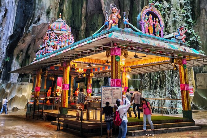 Batu Caves and Sari Experience with Batik Workshop - Dressing in a sari beneath the golden statue